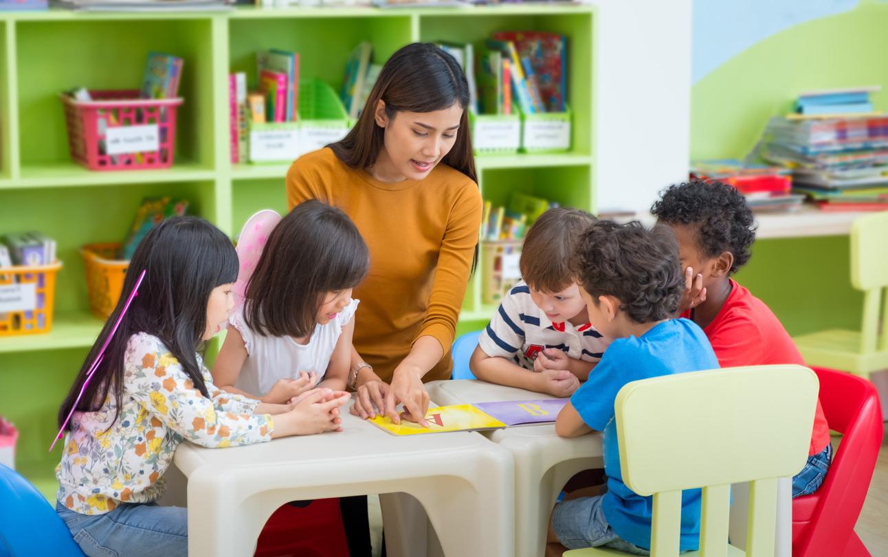 female teacher teaching group of children